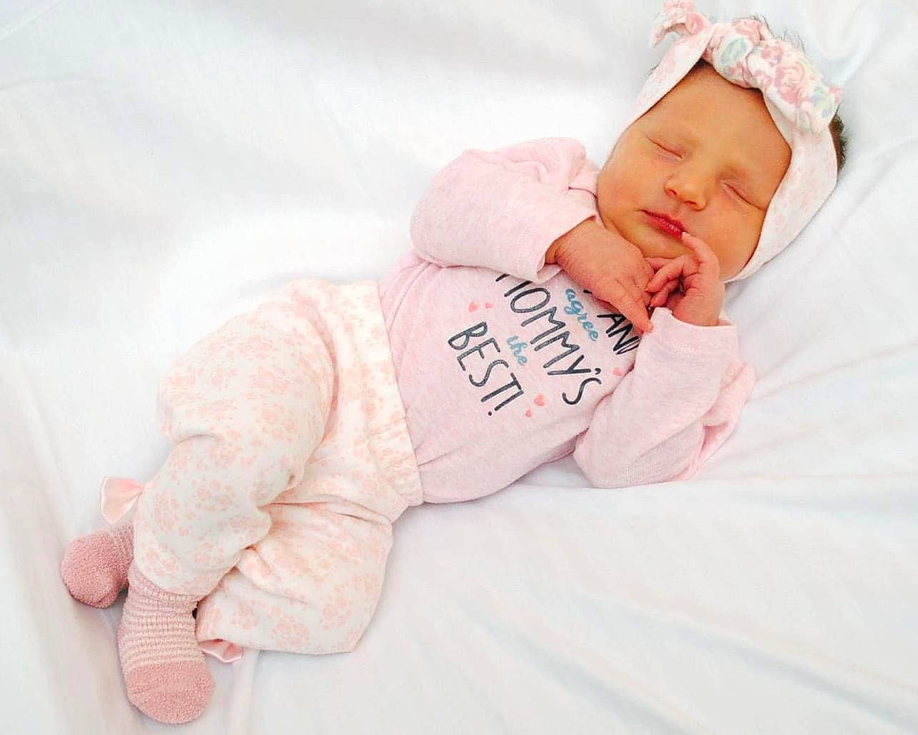 Callie is registered to the contest to win money with this photo: arm, baby, baby_products, baby_sleeping, baby_toddler_clothing, child, comfort, face, flesh, foot, hand, headwear, linens, pattern, peach, person, portrait_photography, sitting, sleep, sleeve