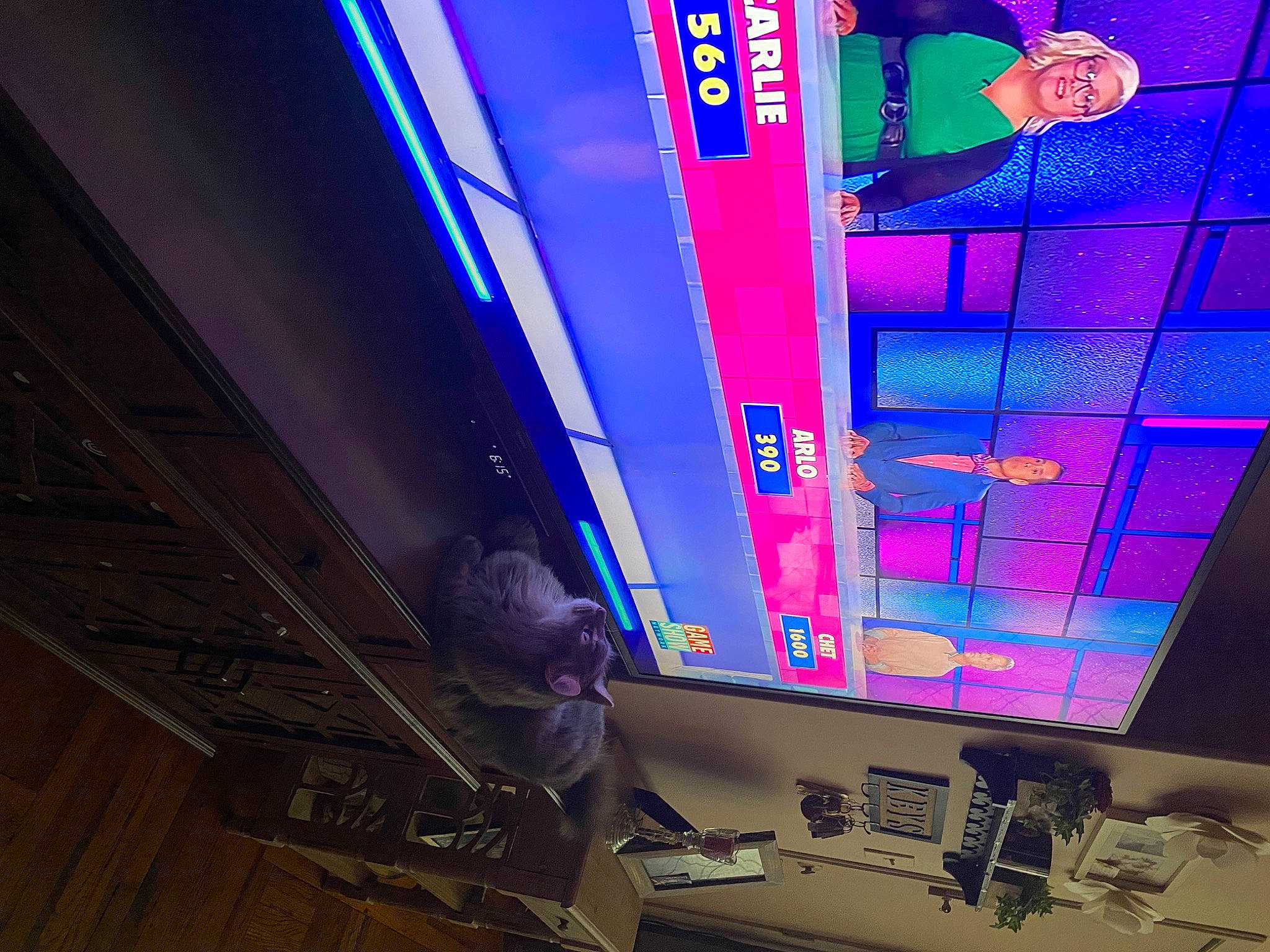 Dixon is registered to the contest to win money with this photo: art, building, ceiling, display_device, electric_blue, electronic_device, electronic_signage, entertainment, event, font, games, machine, magenta, multimedia, neon, purple, room, signage, space, visual_effect_lighting