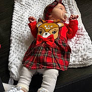Novah is registered to the contest to win money with this photo: baby, infant, pacifier, red_dress, plaid, headband, deer_applique, white_blanket, white_shoes, cozy, cute, child, lying_down, soft_texture, floor, indoors, small_hands, toddler, fashion, accessory