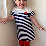 Joy a rejoint le concours — aidez-le/la à gagner de superbes lots ! toddler, child, smiling, standing, striped_dress, red_leggings, headband, pink_table, unicorn_pattern, strawberry_pattern, indoor, wall, happy, person, feet, socks, cute, portrait, fashion, playful