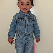 Joy a rejoint le concours — aidez-le/la à gagner de superbes lots ! toddler, child, denim_jacket, denim_pants, standing, pigtails, smiling, pacifier, pink_chair, indoor, socks, cute, portrait, happy, young_child, person, clothing, full_body, wall, footwear