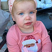 Alexandria is registered to the contest to win money with this photo: toddler, child, blue_eyes, pink_headband, pink_shirt, santa_claus, sequins, sippy_cup, outdoor, stroller, person, cute, portrait, young_child, fashion, holiday_theme, expression, face, casual, daylight