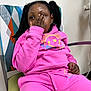 Prayze joined the competition — help win amazing prizes! child, pink_tracksuit, sitting, chair, hand_on_face, indoor, geometric_pattern, casual_clothing, relaxed_pose, person, young, portrait, dreadlocks, colorful, furniture, expression, comfort, modern, home, playful