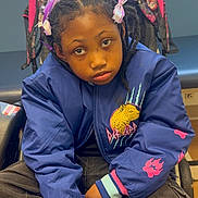 Prayze joined the competition — help win amazing prizes! child, braided_hair, ribbons, blue_jacket, leopard_graphic, pink_paw_prints, stroller, indoor, window, bench, cross_legged, pensive_expression, casual_clothing, person, portrait, seated, young, fashion, hands, face
