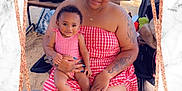 Kayley joined the competition — help win amazing prizes! woman, baby, child, outdoor, sand, picnic, stroller, table, food_container, bag, tattoo, red_dress, checkered_pattern, smile, sitting, footwear, nail_polish, family, portrait, sunlight