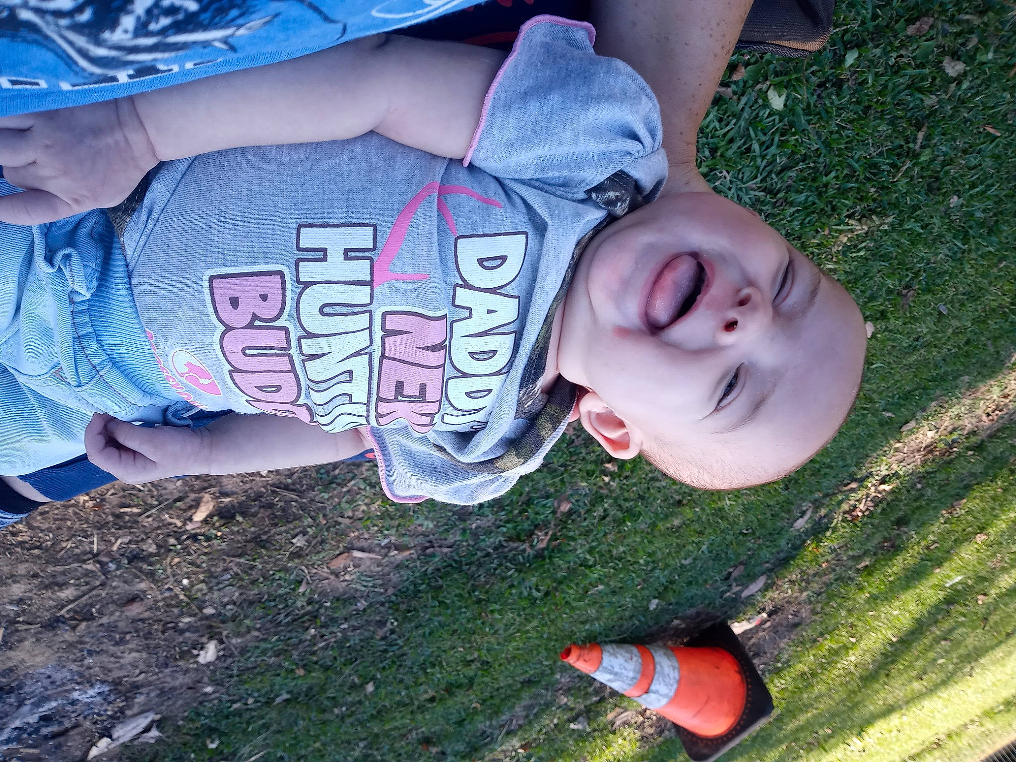 Denise is registered to the contest to win money with this photo: baby, blue, carmine, child, cool, elbow, fun, grass, happy, human_leg, leisure, people_in_nature, person, plant, recreation, sitting, sleeve, soil, toddler, tree