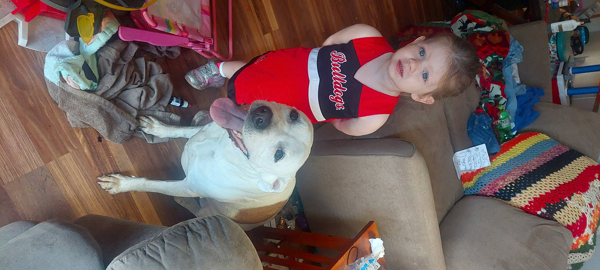 Georgia is registered to the contest to win money with this photo: baby_toddler_clothing, carmine, child, comfort, companion_dog, couch, dog, dog_breed, event, fun, holiday, human_leg, knee, lap, leg, room, smile, thigh, toddler, vertebrate