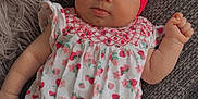 Bella Rose is registered to the contest to win money with this photo: baby, infant, headband, bow, pink, romper, strawberry_pattern, floral_pattern, cute, lying_down, texture, fabric, soft, cozy, skin, hand, face, expression, indoors, child