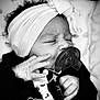Valencia is registered to the contest to win money with this photo: baby, pacifier, headband, black_and_white, newborn, infant, sleeping, hand, clothing, cute, portrait, closeup, peaceful, soft, adorable, child, face, monochrome, bed, blanket