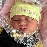 Valencia joined the competition — help win amazing prizes! baby, sleeping, hat, yellow_hat, lace, pearls, pink_blanket, face, infant, child, closeup, soft_texture, clothing, safety_harness, car_seat, newborn, adorable, peaceful, portrait, cute