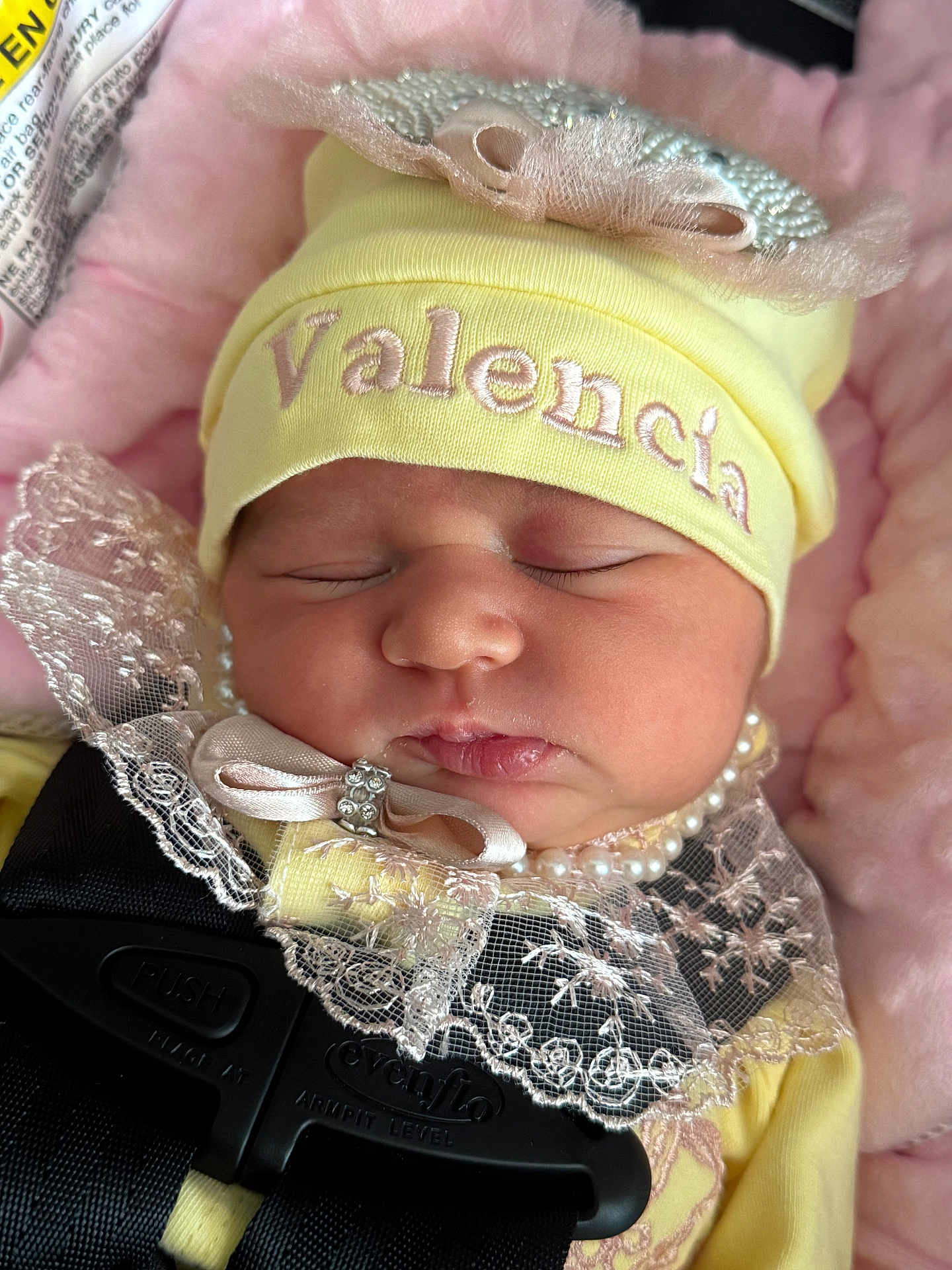 Valencia joined the competition — help win amazing prizes! baby, sleeping, hat, yellow_hat, lace, pearls, pink_blanket, face, infant, child, closeup, soft_texture, clothing, safety_harness, car_seat, newborn, adorable, peaceful, portrait, cute