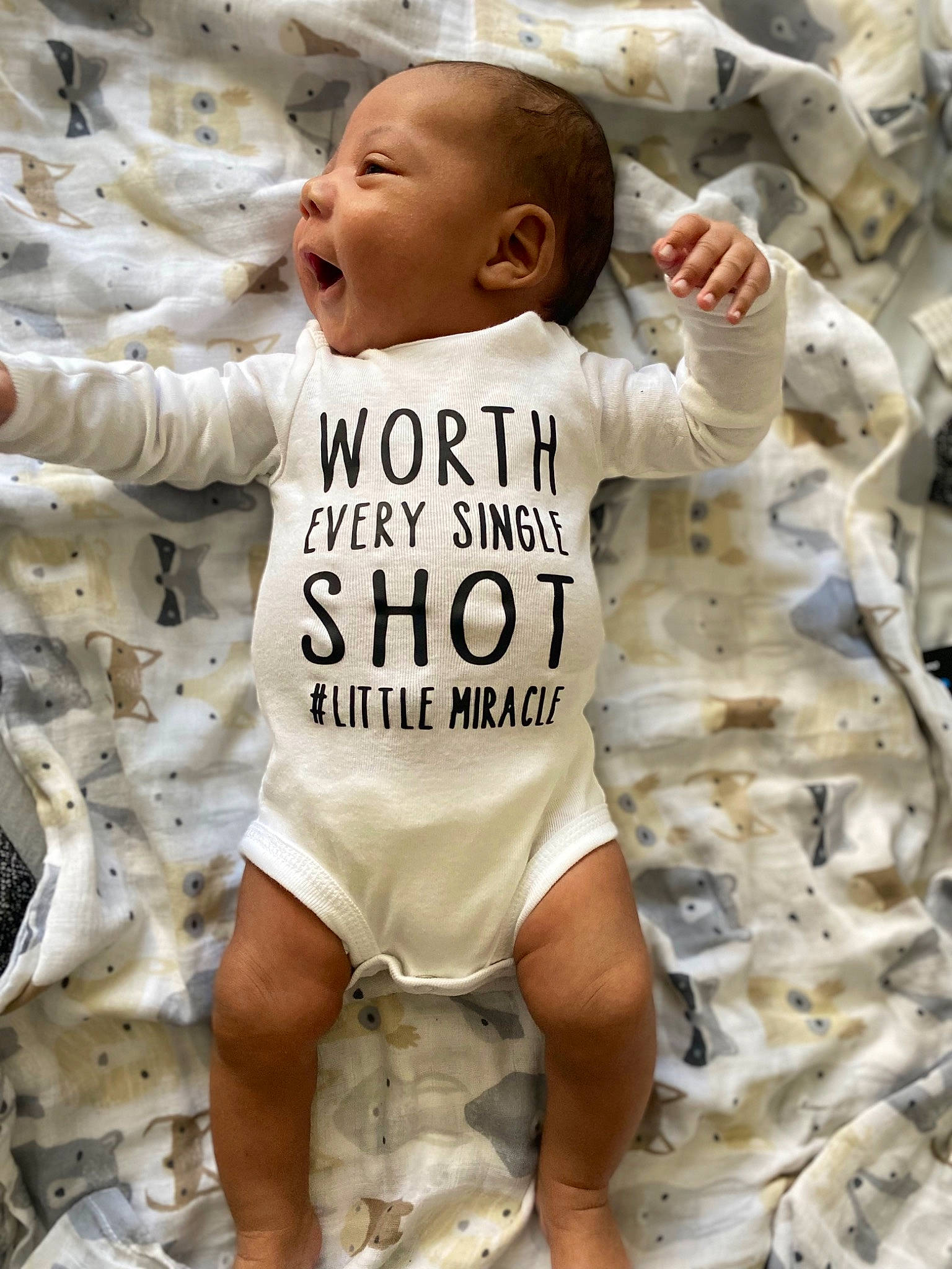 Devante is registered to the contest to win money with this photo: baby, baby_toddler_clothing, child, eye, face, font, fun, gesture, happy, human_body, infant_bodysuit, long_sleeved_t_shirt, people_in_nature, person, photograph, play, sleeve, smile, sportswear, t_shirt