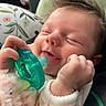 Brielle is registered to the contest to win money with this photo: newborn, baby, infant, sleeping, pacifier, face, hands, fist, hair, portrait, close_up, indoors, cozy, blanket, floral, cushion, plush_toy, clothing, peaceful, cute