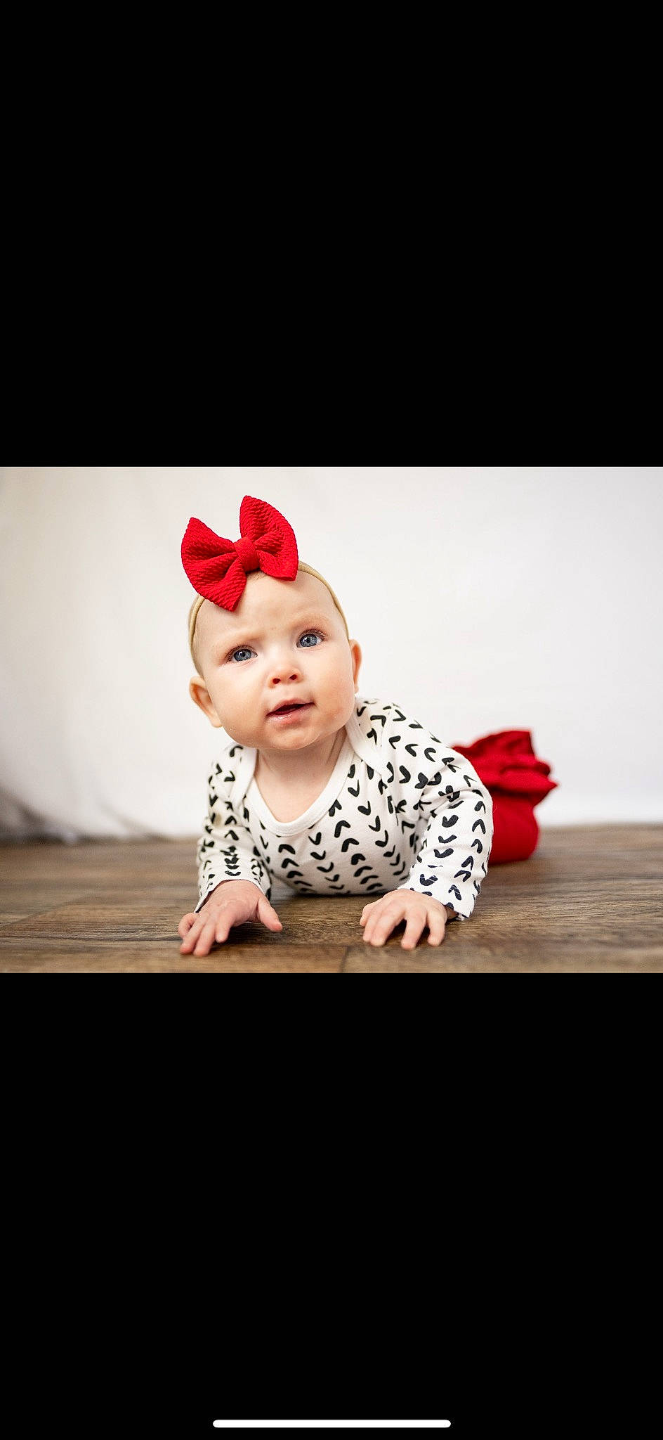 Harper is registered to the contest to win money with this photo: baby, baby_toddler_clothing, beanie, carmine, child, costume_hat, flash_photography, flooring, font, happy, human_body, pattern, person, plant, portrait_photography, sitting, sleeve, smile, toddler, tree