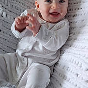 Rita joined the competition — help win amazing prizes! baby, smiling, infant, white_pajamas, blanket, knit_blanket, happy, sitting, face, hands, cute, child, indoor, cozy, portrait, soft_texture, young_child, one_person, light, closeup