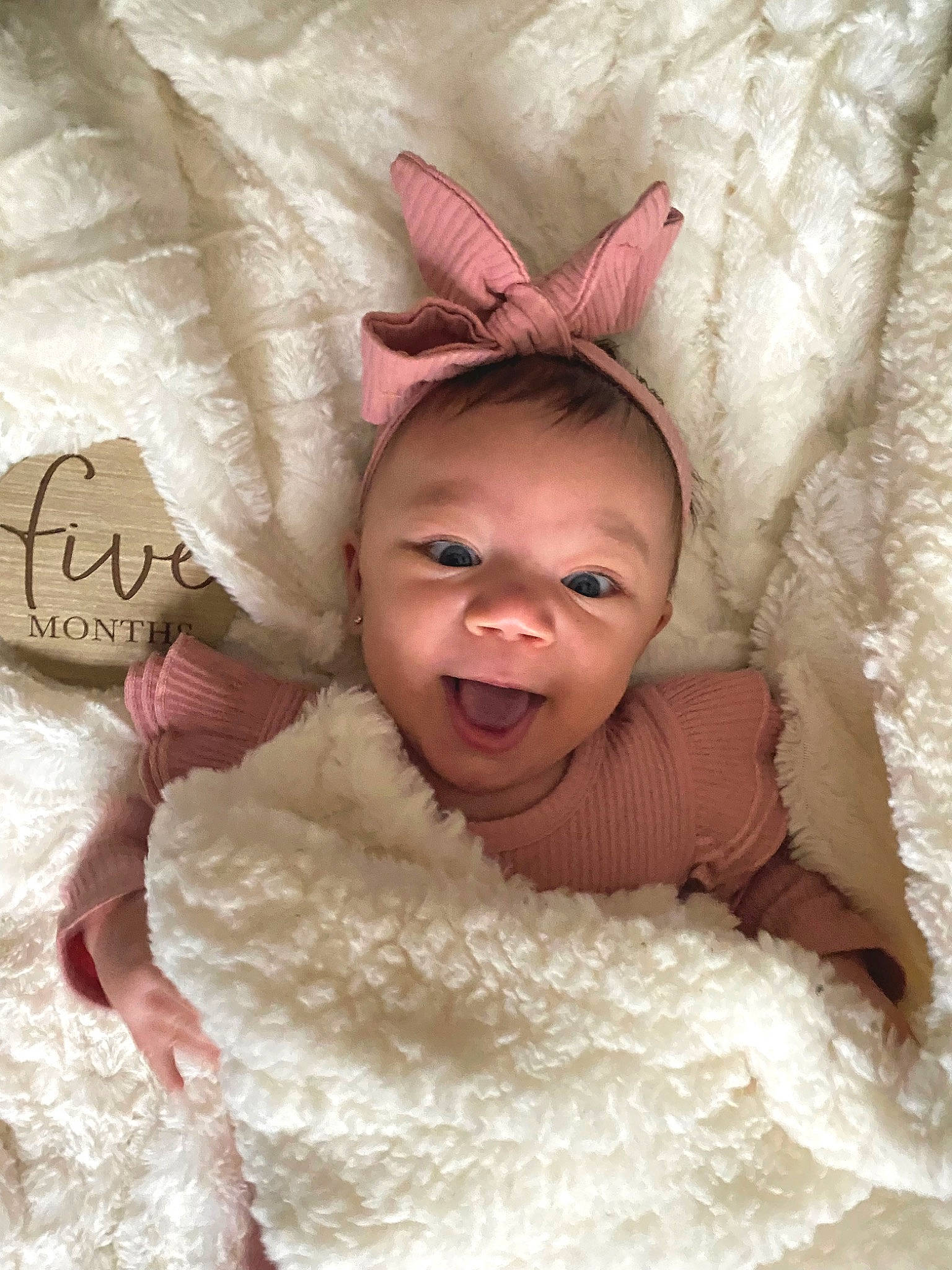 Elianna is registered to the contest to win money with this photo: baby, comfort, costume_hat, eye, eyebrow, fawn, finger, happy, head, headgear, human_body, linens, mammal, neck, person, pink, skin, smile, textile, toddler
