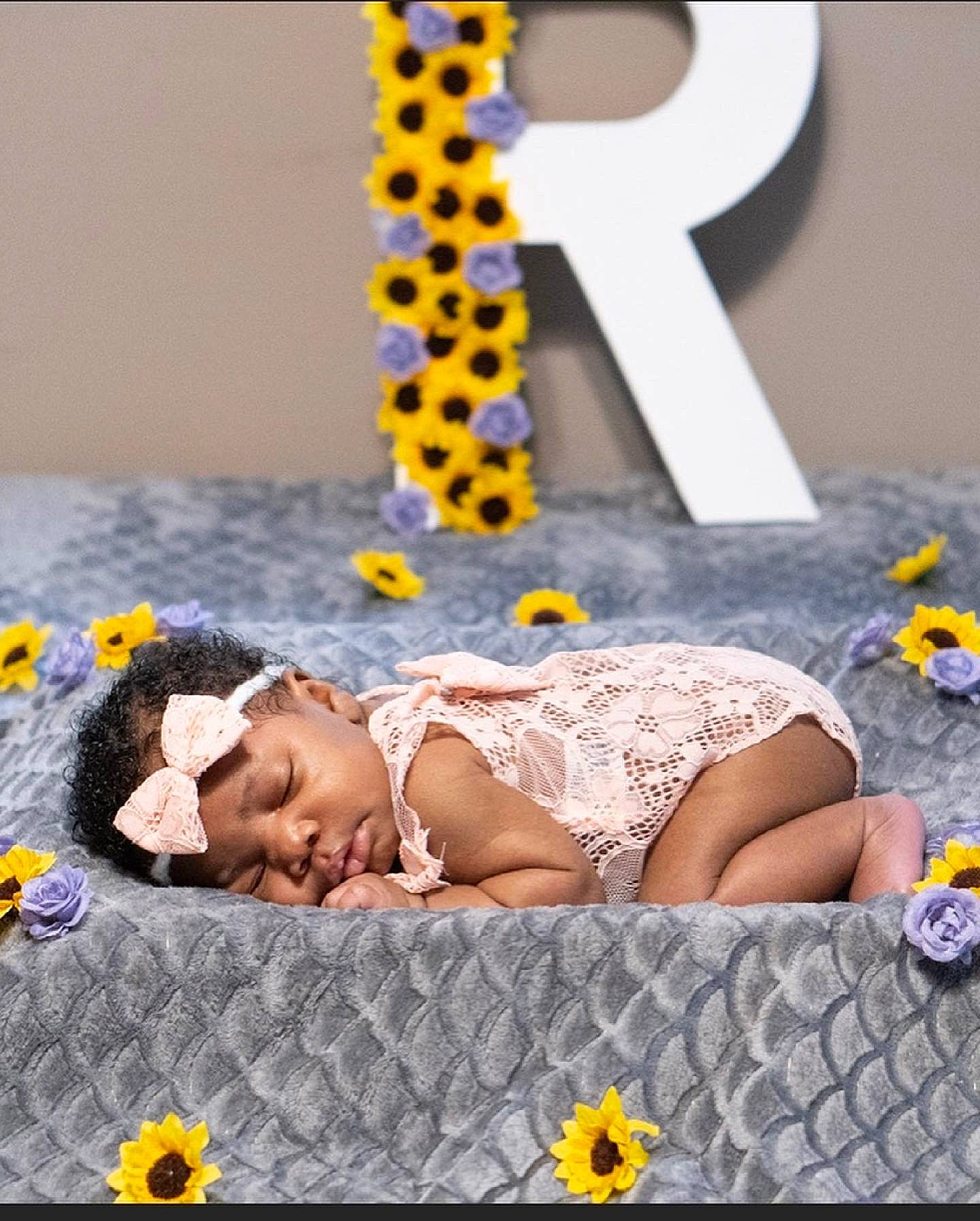 River Sage is registered to the contest to win money with this photo: art, baby, bed, bedding, child, event, fashion_accessory, flower, fun, happy, headgear, headpiece, leisure, linens, pattern, person, petal, textile, thigh, toddler
