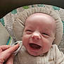 Kaison joined the competition — help win amazing prizes! baby, infant, smiling, laughing, hand, clothing, blanket, cushion, face, head, person, portrait, indoor, soft_texture, cozy, baby_garment, skin, happy, newborn, comfort
