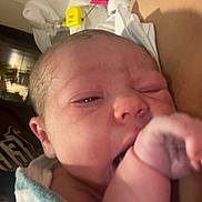 Carter joined the competition — help win amazing prizes! newborn, baby, infant, child, portrait, face, eyes, fist, blanket, swaddled, hospital, medical, parent, adult, cuddling, close_up, indoors, sleepy, winking, family