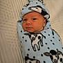 Alexander is registered to the contest to win money with this photo: baby, newborn, blanket, blue_blanket, cow_pattern, infant, wrapped, cute, sleeping_area, bed, soft_texture, child, portrait, headwear, warm, resting, indoor, cozy, infant_face, peaceful