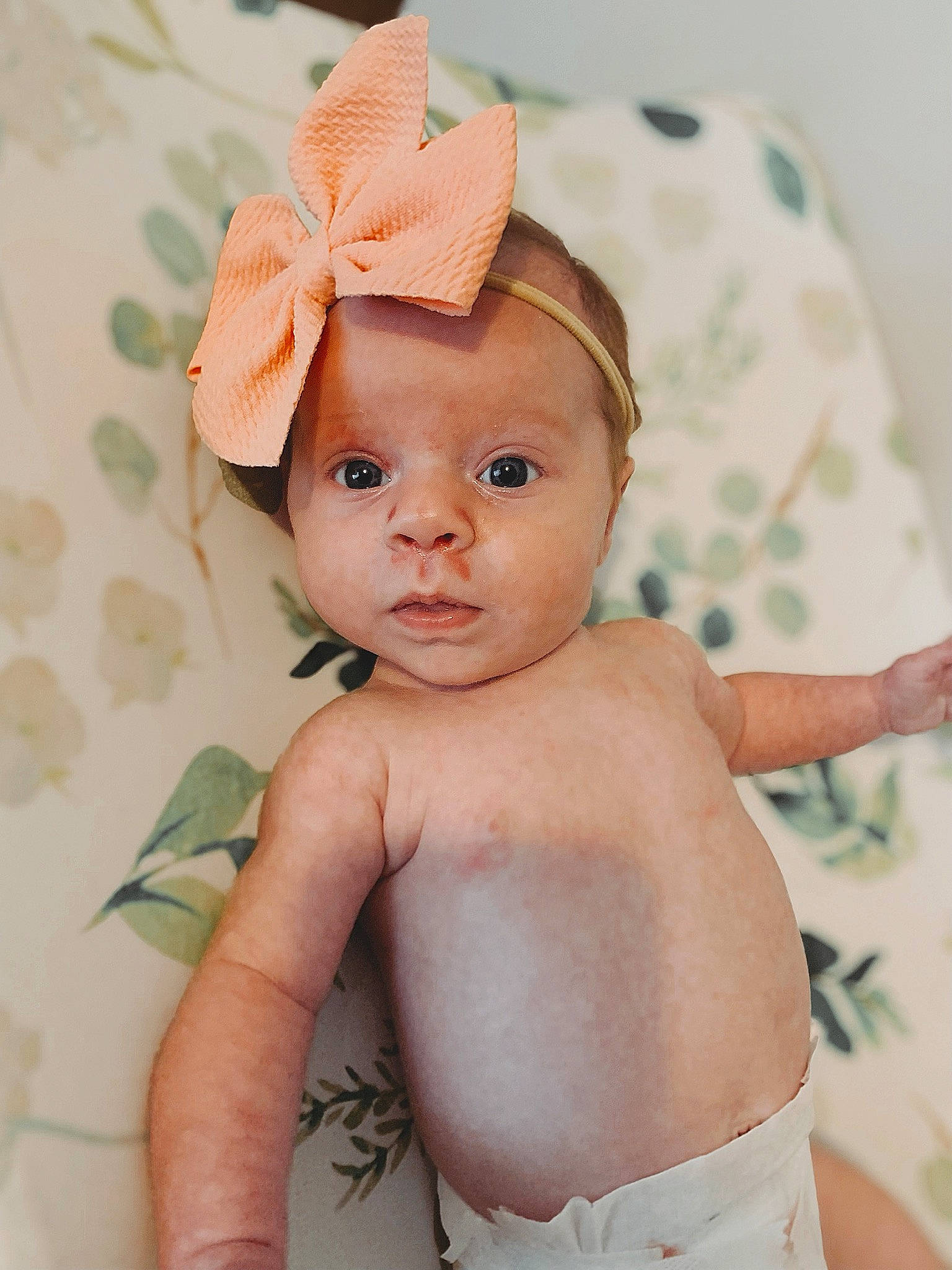 Kyndallyn is registered to the contest to win money with this photo: baby, baby_toddler_clothing, cap, child, costume_hat, eye, eyebrow, eyelash, face, fashion_accessory, hair_accessory, happy, hat, head, headpiece, lip, peach, person, skin, thumb