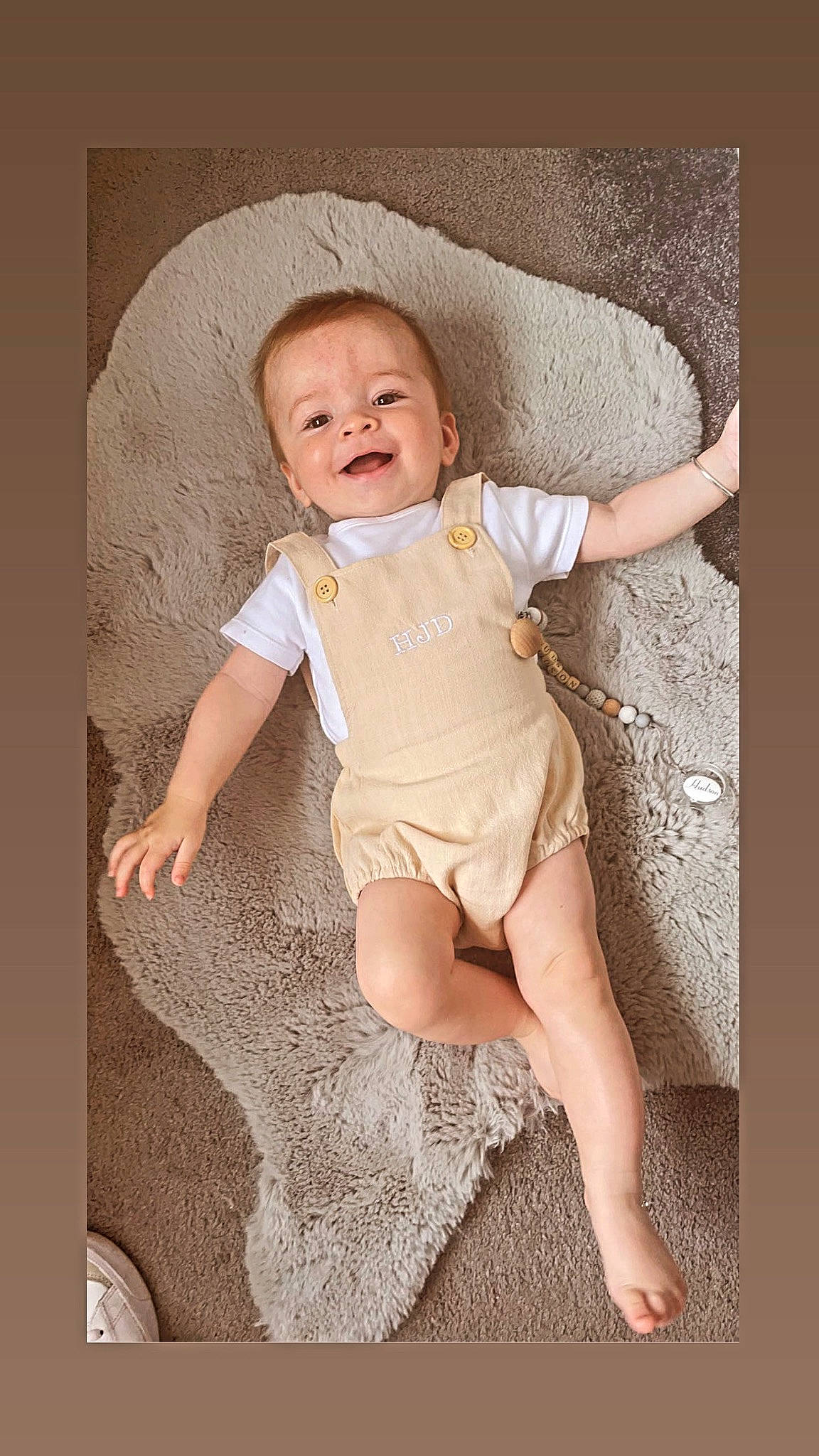 Hudson is registered to the contest to win money with this photo: baby, baby_toddler_clothing, cheek, child, comfort, eye, face, flash_photography, foot, happy, human_body, human_leg, knee, neck, pattern, person, sitting, sleeve, smile, thigh