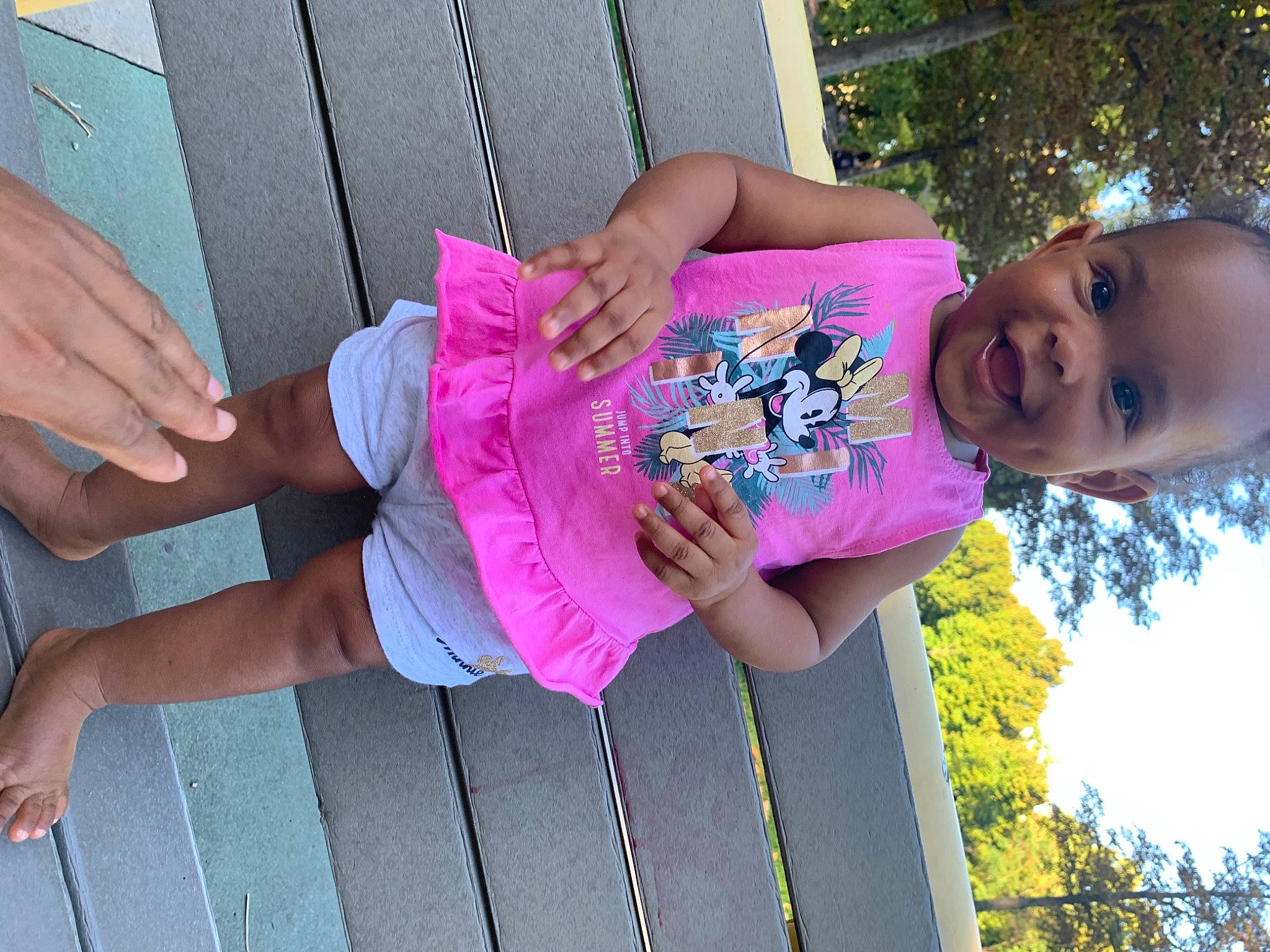 Julia participe au concours pour gagner de l'argent avec cette photo : facial_expression, finger, fun, green, hand, happy, hat, joint, leisure, person, pink, plant, public_space, purple, red, shorts, skin, smile, toddler, tree