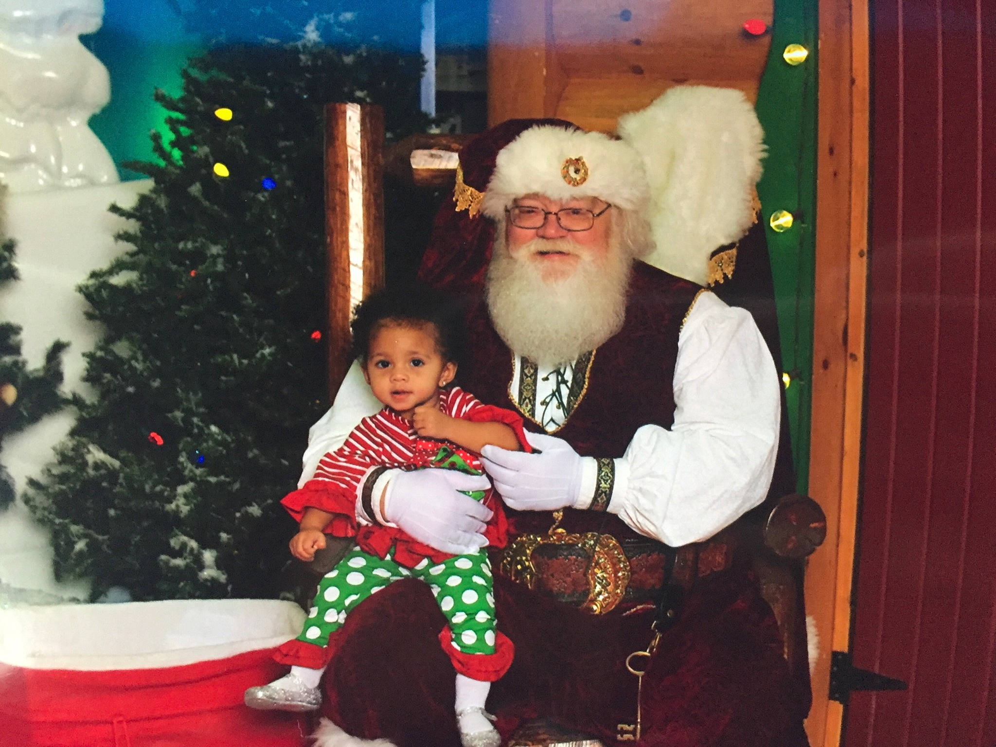 Zarianna is registered to the contest to win money with this photo: christmas, christmas_decoration, event, facial_hair, fictional_character, fun, headwear, holiday, lap, person, product, santa_claus, tradition