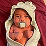 baby, blanket, bodypart, bonnet, clothing, face, finger, hand, hat, head, hood, hoodie, knitwear, newborn, person, photography, portrait, sweater, sweatshirt, towel
