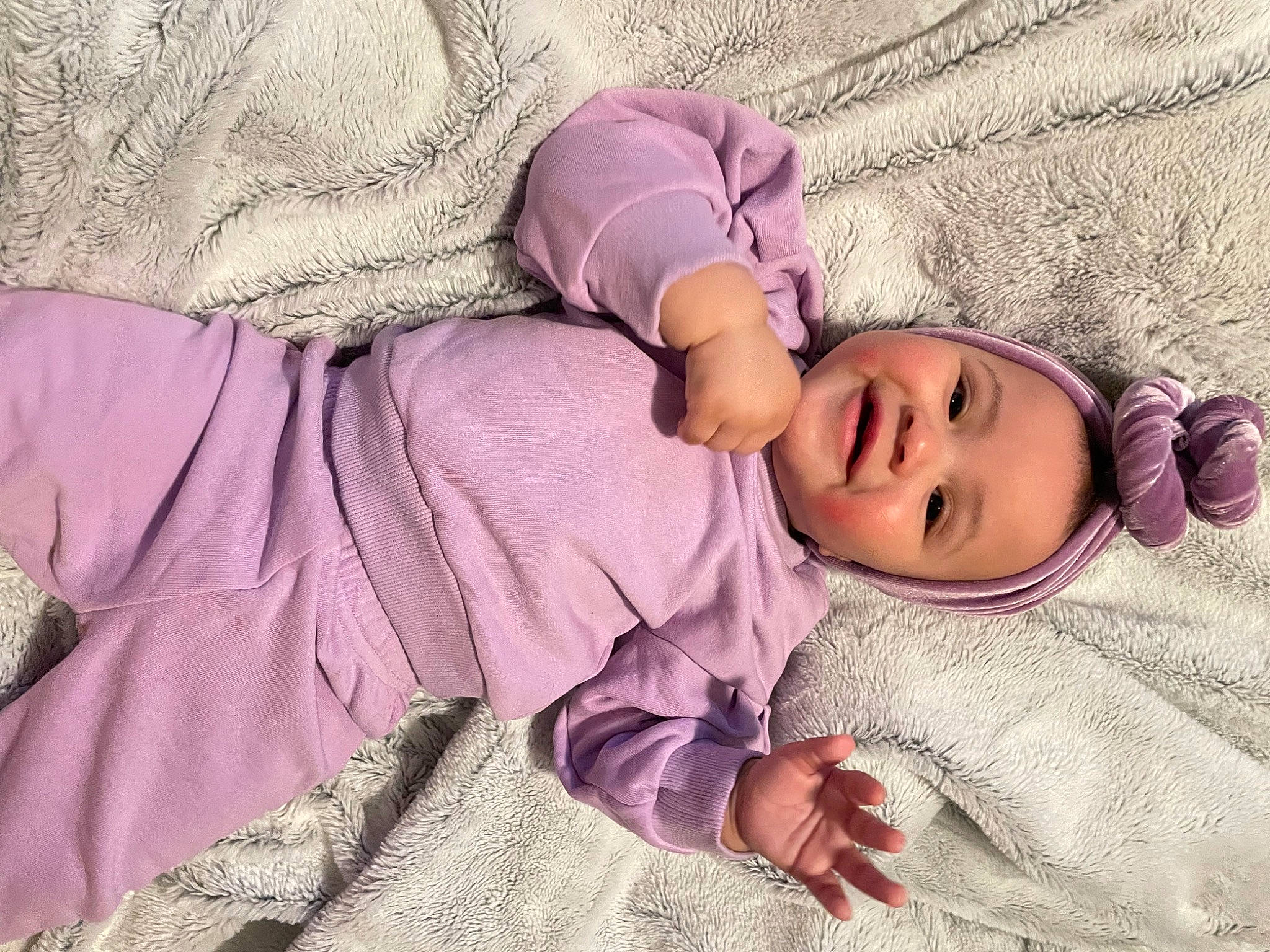 Deja is registered to the contest to win money with this photo: arm, baby, baby_sleeping, baby_toddler_clothing, cheek, child, comfort, headwear, human_body, leg, linens, magenta, outerwear, person, pink, product, purple, skin, sleeve, smile