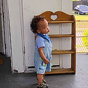 Octavius joined the competition — help win amazing prizes! toddler, child, porch, overalls, blue_bandana, colorful_shoes, wooden_shelf, heart_cutout, car, grass, outdoor, concrete_floor, door, curly_hair, side_profile, standing, casual_clothing, daylight, expression, small_person
