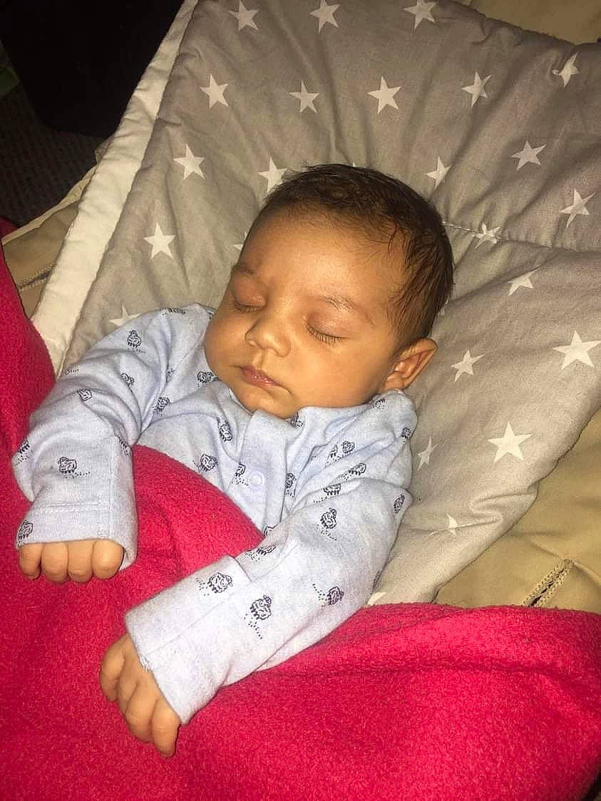 Dominik is registered to the contest to win money with this photo: baby, baby_products, baby_sleeping, baby_toddler_clothing, cheek, chin, comfort, eye, facial_expression, hairstyle, human_body, iris, linens, lip, mammal, mouth, nose, person, skin, sleeve