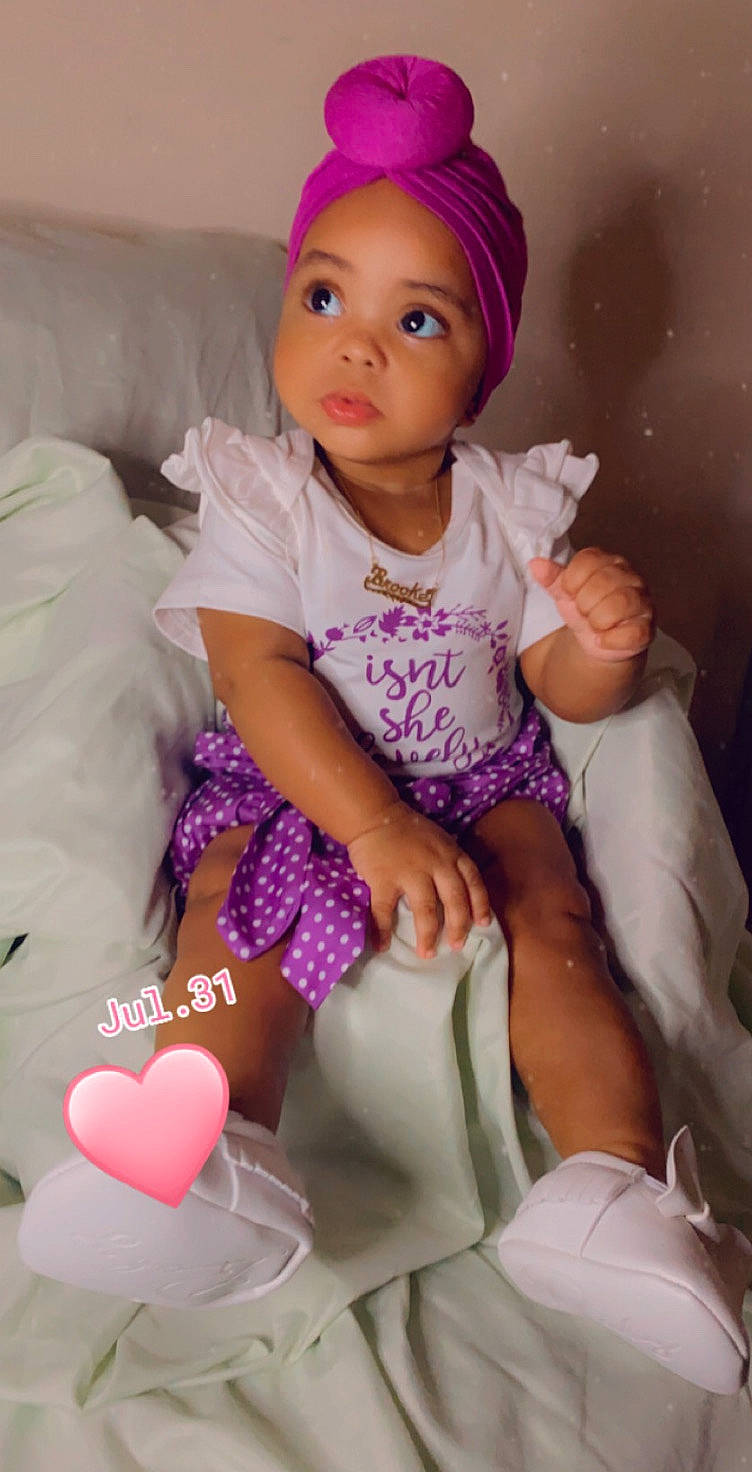 Brooke joined the competition — help win amazing prizes! arm, baby_toddler_clothing, comfort, face, fun, happy, head, headwear, magenta, organ, person, pink, product, purple, sitting, skin, sleeve, textile, thigh, toddler