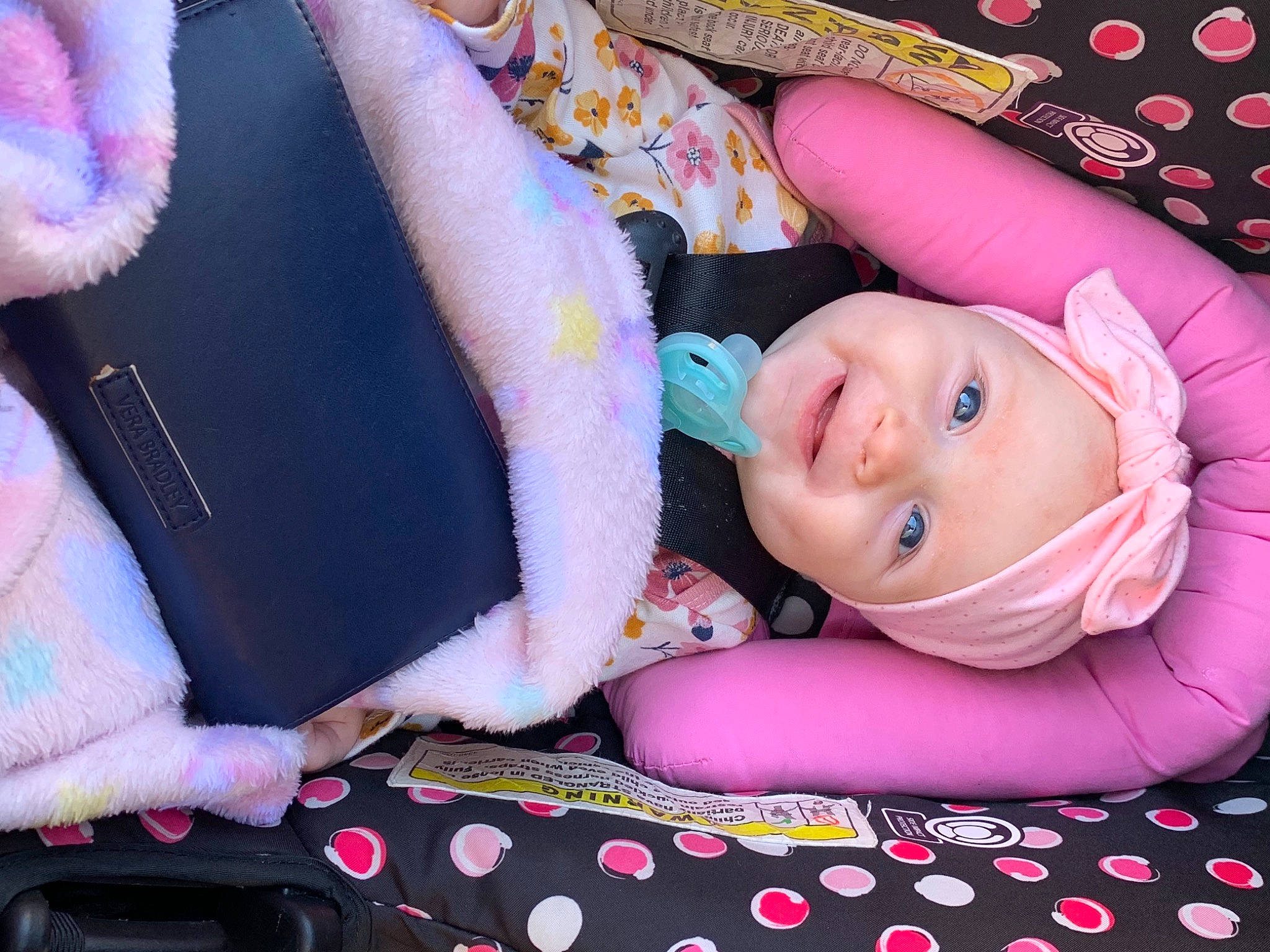 Ophelia is registered to the contest to win money with this photo: baby, baby_laughing, baby_products, baby_toddler_clothing, cheek, child, comfort, finger, fun, happy, headwear, iris, magenta, pattern, person, pink, purple, skin, smile, textile