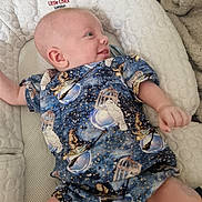 Lucas is registered to the contest to win money with this photo: baby, infant, child, smiling, blue_clothing, bird_pattern, cushion, baby_lounger, soft_texture, indoor, happy, portrait, cute, relaxed, cozy, newborn, person, skin, hand, face