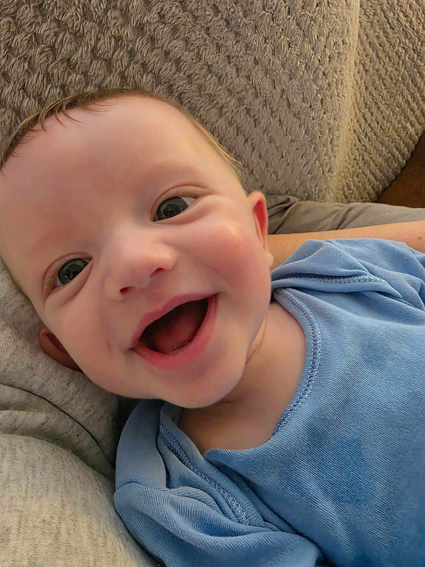 Lucas joined the competition — help win amazing prizes! baby, smiling, happy, blue_clothing, face, infant, close_up, cute, child, lying_down, texture, soft_surface, portrait, skin, eyes, mouth_open, expression, young_child, head, indoors