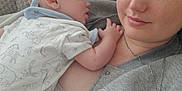 Lucas is registered to the contest to win money with this photo: baby, blanket, casual, closeup, clothing, comfort, couch, face, head, holding, indoor, necklace, person, portrait, relaxation, rest, skin, sleeping, tenderness, woman