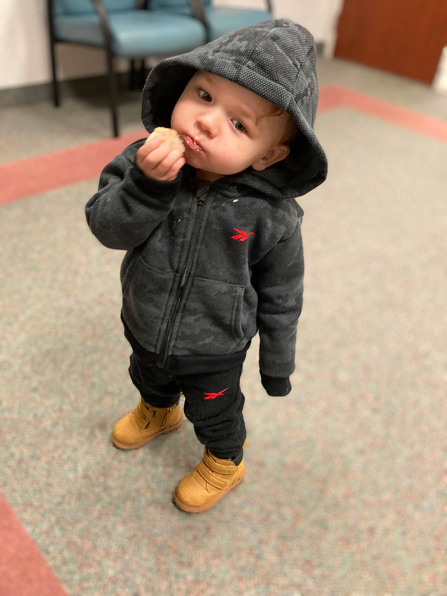 Nikko is registered to the contest to win money with this photo: baby, baby_toddler_clothing, cap, cheek, child, eye, face, flooring, fun, fur, happy, head, headgear, headwear, jacket, nose, pattern, person, skin, sleeve