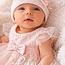 baby, infant, girl, pink_dress, lace, hat, bow, pearls, soft_blanket, portrait, cute, child, newborn, smiling, face, headwear, tulle, adorable, closeup, laying_down