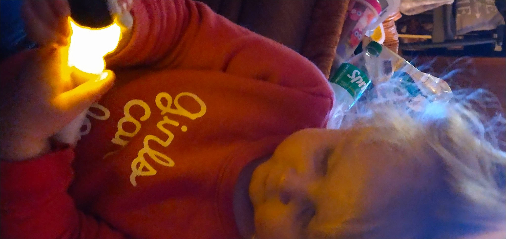 Riley is registered to the contest to win money with this photo: abdomen, baby, chest, child, drink, ear, finger, fun, gesture, happy, heat, light, mouth, nail, night, orange, person, room, thumb, toddler