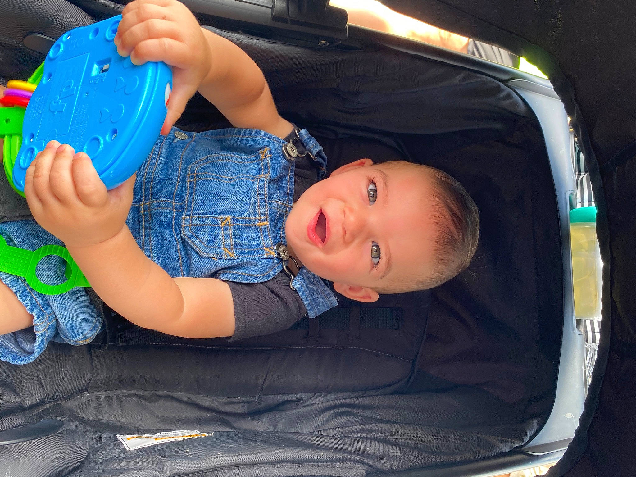 Jett is registered to the contest to win money with this photo: auto_part, automotive_design, automotive_exterior, automotive_lighting, baby_products, baby_toddler_clothing, bumper, car, child, electric_blue, fun, hand, hood, motor_vehicle, person, plastic_bottle, smile, toddler, trunk, vehicle