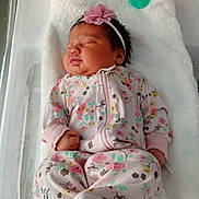 Serenity joined the competition — help win amazing prizes! newborn, baby, sleeping, floral_clothing, headband, pink_flower, hospital_bassinet, blanket, pacifier, infant, cute, peaceful, child, portrait, indoors, resting, soft_texture, cozy, small_hands, closed_eyes