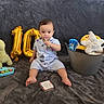 baby, child, toy, balloon, number, plush_toy, basket, blanket, sitting, curious, indoor, clothing, cute, infant, playtime, soft_toy, smile, portrait, decor, relax