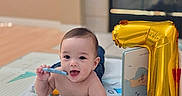 Preston joined the competition — help win amazing prizes! baby, blanket, toy, balloon, number_one, indoor, child, smiling, playing, floor, book, chewing, cute, infant, happy, early_milestone, room, soft_toy, colorful, celebration