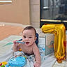 baby, balloon, blanket, book, celebration, chewing, child, colorful, cute, early_milestone, floor, happy, indoor, infant, number_one, playing, room, smiling, soft_toy, toy
