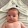 baby, infant, child, towel, hooded_towel, face, skin, bare_chest, blanket, cute, soft_texture, lying_down, indoors, portrait, newborn, expression, relaxed, sleepy, baby_boy, comfort