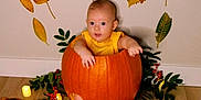 Ethan joined the competition — help win amazing prizes! baby, pumpkin, yellow_clothing, autumn_leaves, candles, floor, wall, indoor, festive, fall, decoration, greenery, berries, cute, child, sitting, holiday, seasonal, orange, celebration