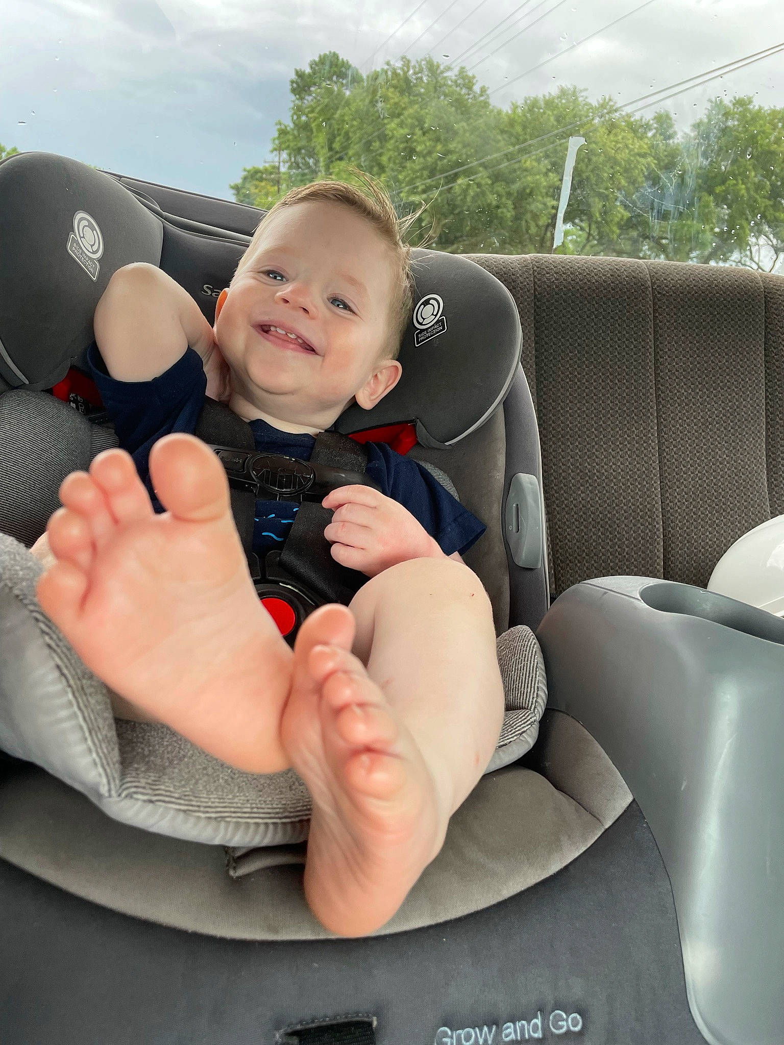 Klay joined the competition — help win amazing prizes! automotive_design, baby, car, car_seat, chair, cloud, comfort, finger, gesture, happy, joy, leg, motor_vehicle, person, sky, smile, steering_part, steering_wheel, thumb, toddler