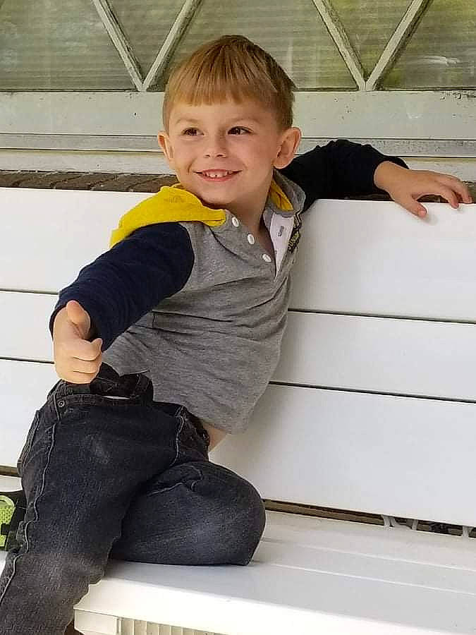 Dylan is registered to the contest to win money with this photo: baby_toddler_clothing, fun, happy, human_leg, joint, joy, knee, leg, leisure, outdoor_shoe, person, shoulder, sitting, sleeve, smile, sock, sportswear, standing, t_shirt, thigh