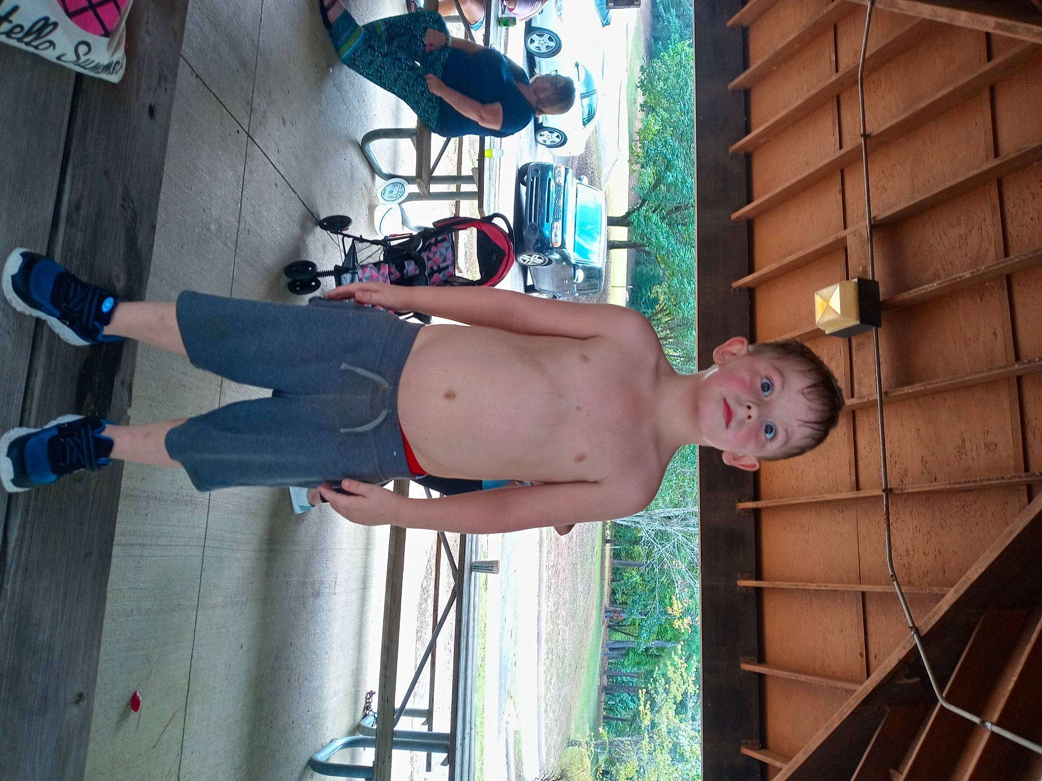 Dylan is registered to the contest to win money with this photo: abdomen, barechested, calf, chest, elbow, flesh, foot, fun, human_leg, knee, leg, leisure, navel, person, physical_fitness, sandal, sitting, swimwear, thigh, trunk